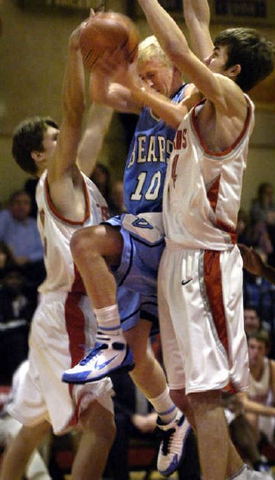 
Central Valley's Kevin Cameron  drives to the basket between Ferris' Beau Brett, left, and Morgan Hyslop in a GSL game Friday night that the Saxons won 70-48. 
 (Holly Pickett / The Spokesman-Review)