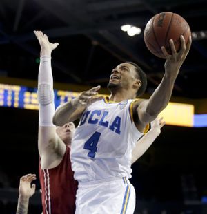 UCLA guard Norman Powell, who scored a career-high 28 points, shoots over Washington State forward Brett Boese. (Associated Press)