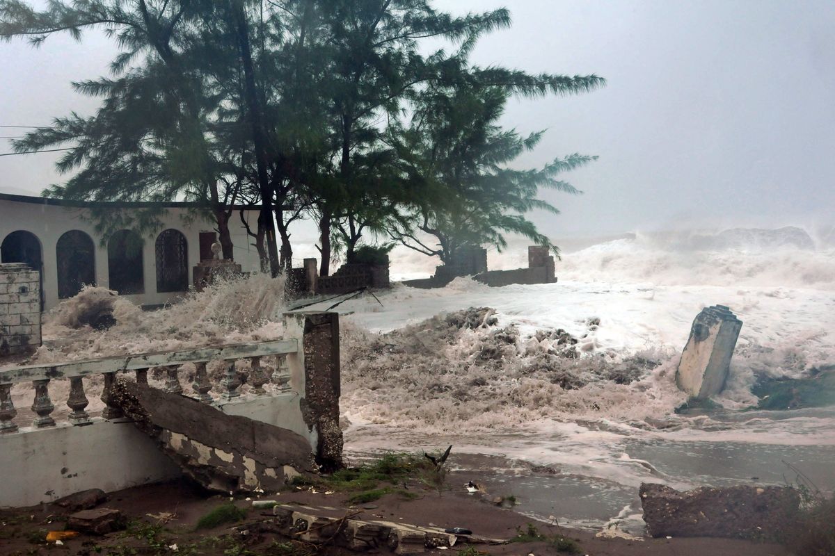 Waves, brought by Hurricane Sandy, crash on a house in the Caribbean Terrace neighborhood in eastern Kingston, Jamaica, Wednesday, Oct. 24, 2012. Hurricane Sandy pounded Jamaica with heavy rain as it headed for landfall near the country