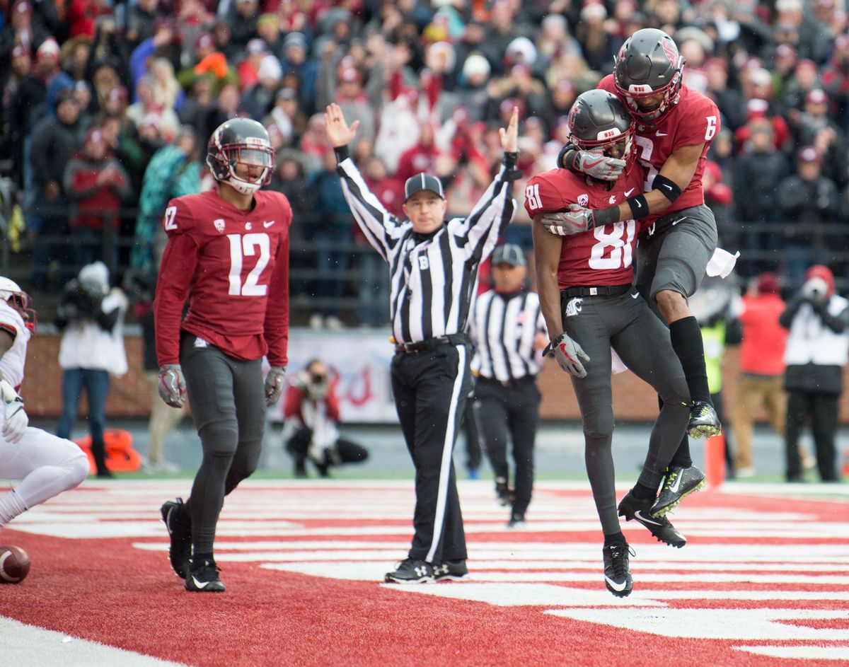 WSU players celebrate during the first half of a college football game on Saturday, November 4, 2017, at Martin Stadium in Pullman, Wash. WSU led 14-7 at the half. (Tyler Tjomsland / The Spokesman-Review)