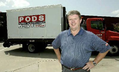 Pete Warhurst, founder and president of PODS, Personal On Demand Storage with one of the company's storage holders.
(Associated Press / The Spokesman-Review)