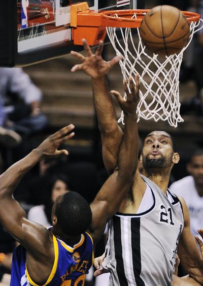 Spurs’ Tim Duncan blocks shot by Warriors’ Harrison Barnes on Tuesday night. (Associated Press)