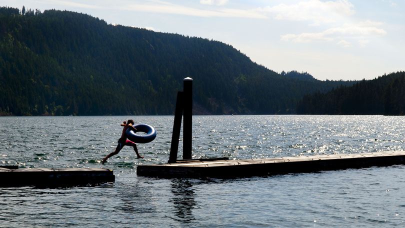 Brody Van Brethorst, 14, of Weiser, Idaho, jumps across the docks near the boat launch at Farragut State Park in Athol on June 23. (Kathy Plonka)