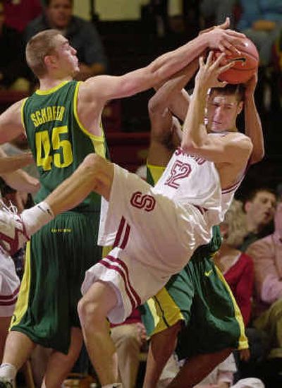 
Stanford forward Matt Haryasz pulls down a rebound in front of Oregon center Ray Schafer in the second half. 
 (Associated Press / The Spokesman-Review)