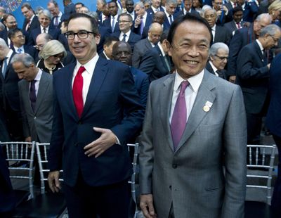 U.S. Treasury Secretary Steve Mnuchin, left, and Japan's Finance Minister Taro Aso attend the International Monetary Fund (IMF) Governors group photo at World Bank/IMF Spring Meetings, in Washington, Saturday, April 21, 2018. (Jose Luis Magana / Associated Press)