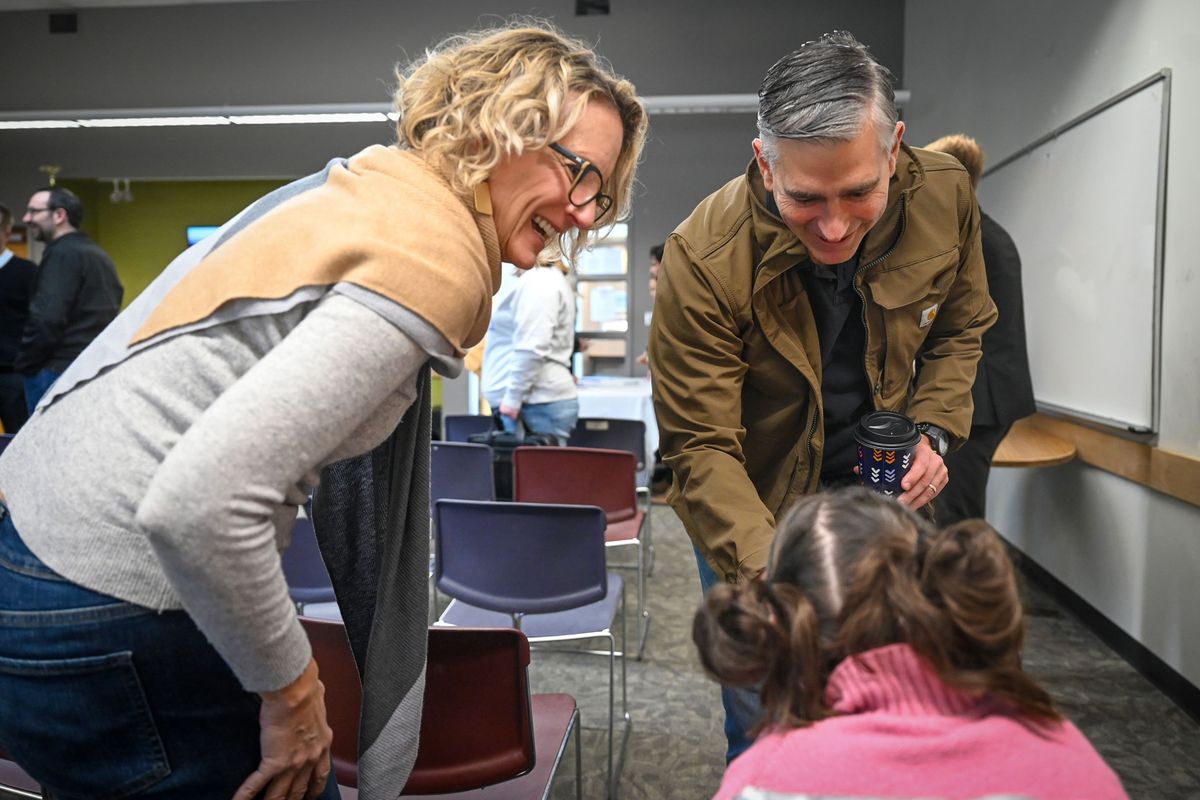Congressman Michael Baumgartner visits with Darci Ladwig, left, and Zoe Osborne before a town hall meeting Saturday at the North Spokane County Library. (DAN PELLE/FOR THE SPOKESMAN-REVIEW)