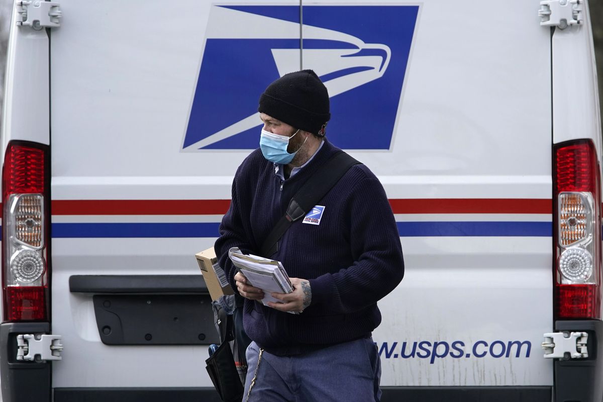 Postal carrier Josiah Morse heads out to deliver mail and packages, Wednesday, Feb. 3, 2021, in Portland, Maine. The U.S. Postal Service