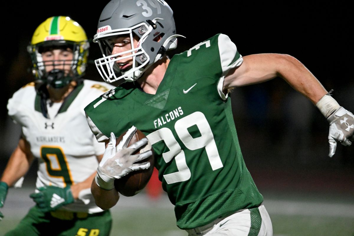 Ridgeline wide receiver Tanner Guard runs for a 44-yard touchdown against Shadle on a pass from quarterback Landon Garner during the first half Friday at Ridgeline High School in Liberty Lake.  (Colin Mulvany/The Spokesman-Review)