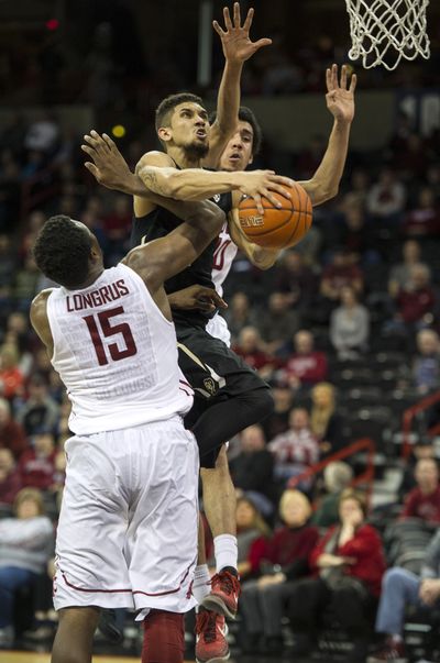 WSU’s Junior Longrus and Dexter Kernich-Drew try to stop Colorado’s Askia Booker in overtime. (Colin Mulvany)