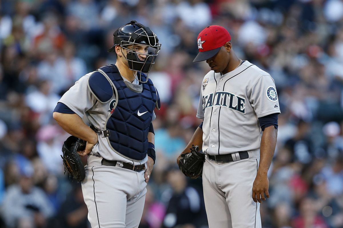 Seattle Mariners starting pitcher Roenis Elias, right, and catcher Mike Zunino meet during the fifth inning. Elias allowed five runs on seven hits over five innings on Friday. (AP)