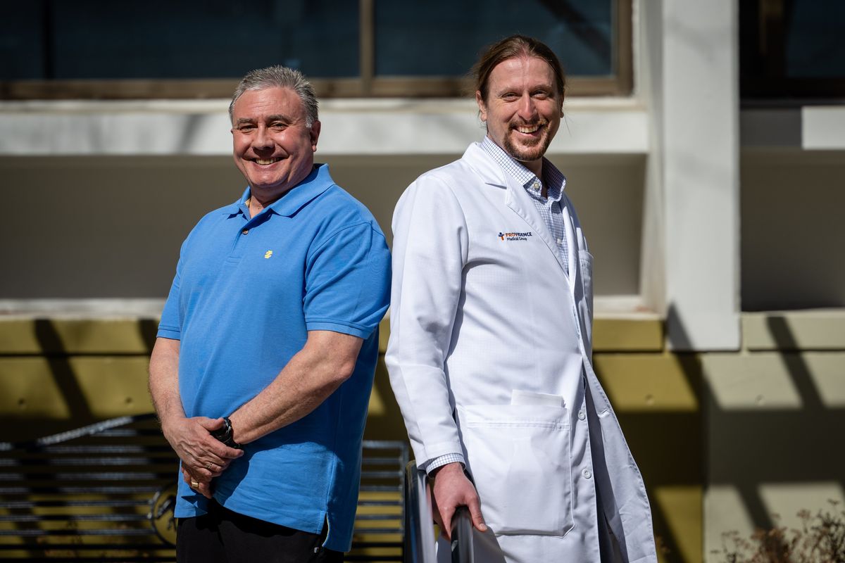 Sixty-year-old Anthony Guastella, left, was injured in December 2020 while working out in his garage. A heavy hook that was holding his workout band dislodged from the ceiling and hit him in the head. He received surgery at Sacred Heart Medical Center for his brain injury and was rehabilitated at St. Luke’s Rehabilitation Medical Center. Dr. Frank Jackson, a Providence Osteopathic Medicine physician, was Guastella’s admitting physician.  (Colin Mulvany/The Spokesman-Review)