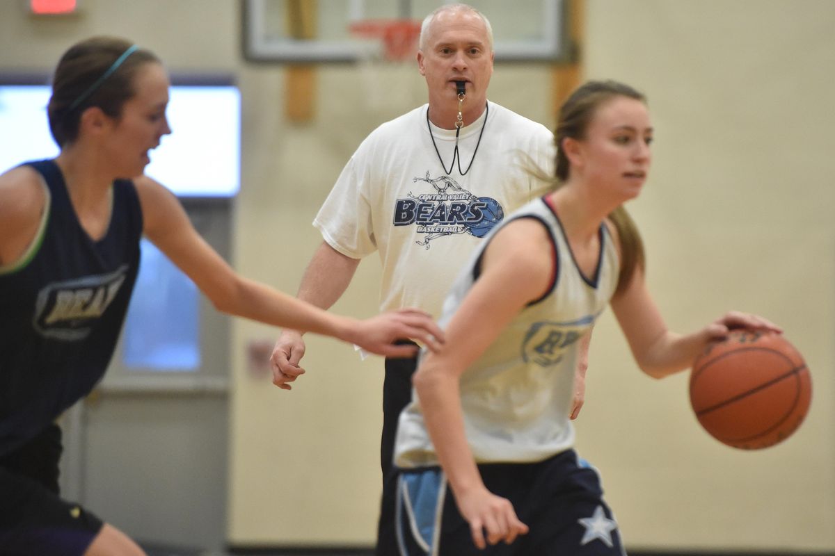 Central Valley head coach Freddie Rehkow guides sophomore Lacie Hull, left, and freshman Kate Sams through drills on Dec. 1, 2015, at CV. (Tyler Tjomsland / The Spokesman-Review)