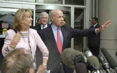 
Former Enron Corp. chairman and CEO Kenneth Lay gestures to the media as he leaves the federal courthouse in Houston with his wife Linda Thursday.
 (Associated Press / The Spokesman-Review)