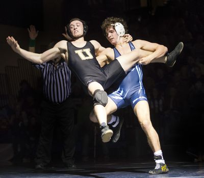 Central Valley 145-pounder Blake Beard, right, prepares to send University’s Dane Driskell to the mat at Battle of the Bone. (Colin Mulvany)