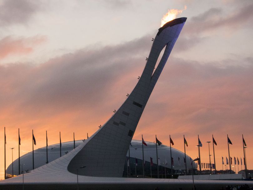 The sun sets behind the Olympic Flame in Sochi, Russia February 11, 2014. BSU at the Games/ Taylor Irby