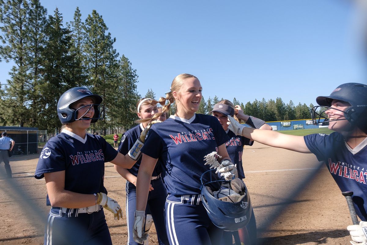Mt. Spokane's Riley Kincaid, center, is congratulated by her teammates after hitting a first-inning home run during a Greater Spokane League game against Mead on Thursday, April 24, 2025, at Mead High School in Spokane, Washington.  (Madison McCord/For The Spokesman-Review)
