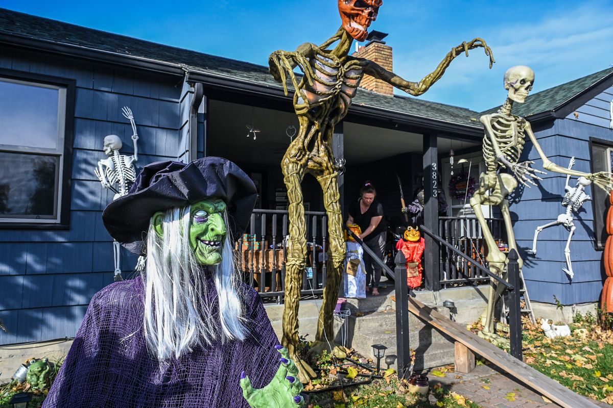 While on her porch Tuesday, Bev Haydon turns on motion-activated Halloween decorations at the corner of Empire Avenue and Pittsburg Street. Haydon is among many Spokane residents who turn their front yards into scary tributes to Halloween and celebrate the annual night of spookiness.  (DAN PELLE/THE SPOKESMAN-REVIEW)
