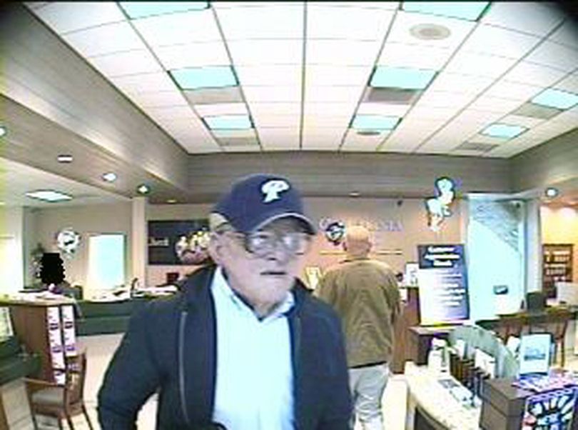 This image provided by the FBI shows a suspect in the process of robbing a bank. The FBI says the elderly, gray-haired bank robber nicknamed the 