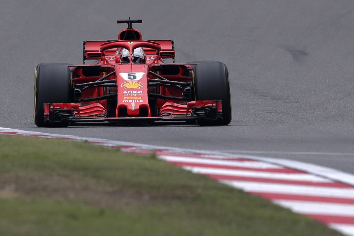 Ferrari driver Sebastian Vettel of Germany steers his car during the qualifying session for the Chinese Formula One Grand Prix at the Shanghai International Circuit in Shanghai, Saturday, April 14, 2018. Vettel took pole position for Sunday’s race. (Andy Wong / Associated Press)