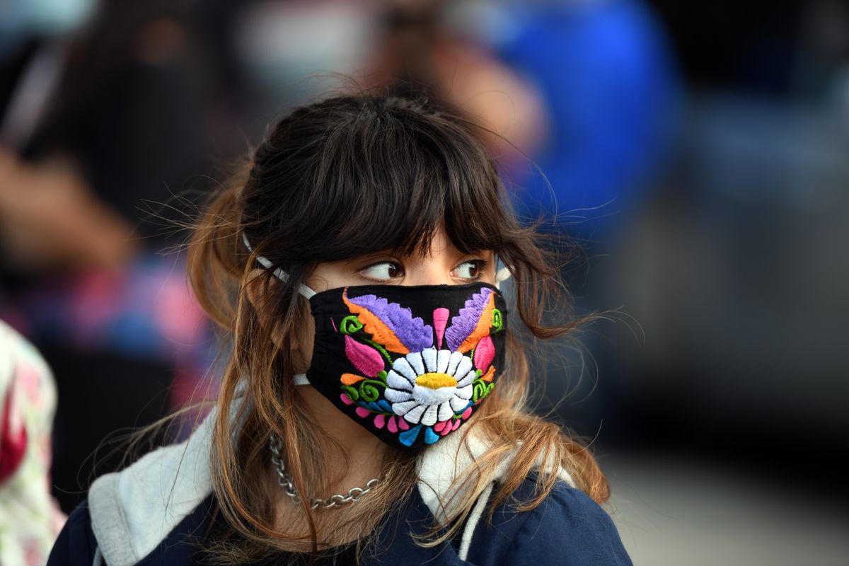 Isabella Amador-Navarrete, 17, listens to speakers during a demonstration in support of the immigration program known as DACA on Monday, June 29, 2020, in downtown Spokane.  (Kathy Plonka / The Spokesman-Review)