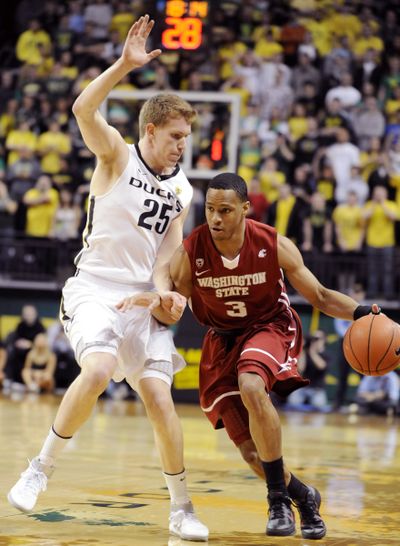 Returning starting point guard Reggie Moore will be counted on to provide stability for Cougars. (Associated Press)