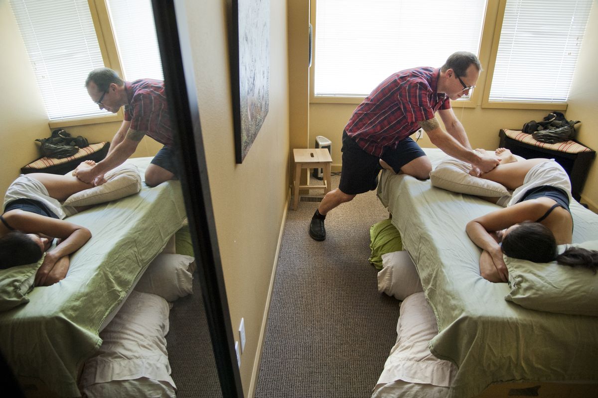 Jake McBurns conducts a Rolfing session with his patient, Melissa Cole, in downtown Spokane. Rolfing is a form of “structural integration,” a line of complementary medicine that uses touch to balance the body and align it with gravity. (Dan Pelle)