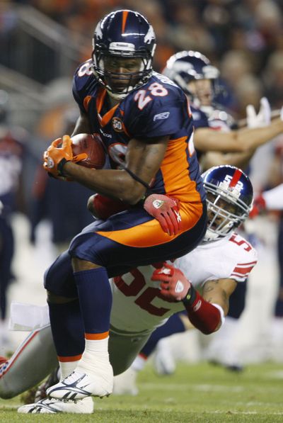 Broncos running back Correll Buckhalter is tackled by New York Giants linebacker Michael Boley.  (Associated Press)