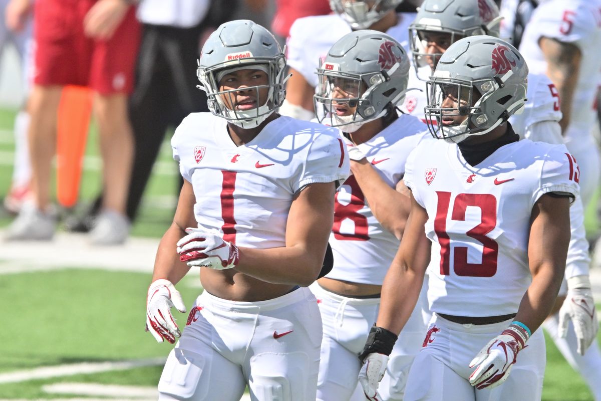 Washington State linebacker Daiyan Henley, left, reacts after sacking the quarterback during the first half of WSU’s Crimson and Gray spring game on Saturday at Gesa Field in Pullman. (Tyler Tjomsland/The Spokesman-Review)