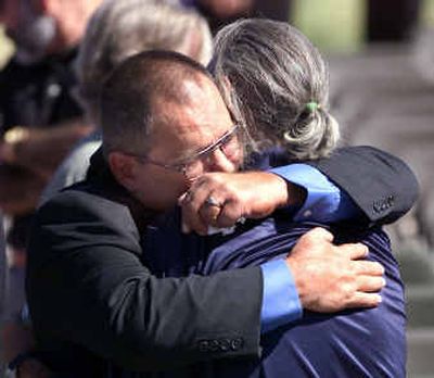 
Dennis Wahrer, left, hugs and is comforted by a well-wisher moments after a service Friday honoring Army Spc. Robert Unruh and his mother, Karen Unruh-Wahrer, at the Southern Arizona Veteran's Memorial Cemetery in Sierra Vista, Ariz.
 (Associated Press / The Spokesman-Review)