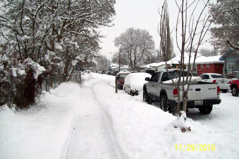 Two pickups frame a completely covered car on East Queen, over the Thanksgiving weekend 2010 (Charles Hansen)