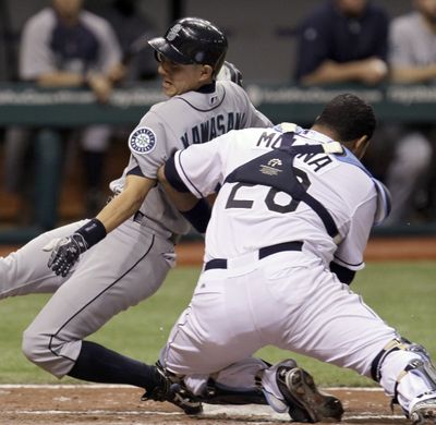 Seattle Mariners' Munenori Kawasaki, of Japan, is tagged out at home plate by Tampa Bay Rays catcher Jose Molina, right, while trying to score on a ball hit by Michael Saunders during the ninth inning of a baseball game Monday, April 30, 2012, in St. Petersburg, Fla. (Chris O'meara / Associated Press)