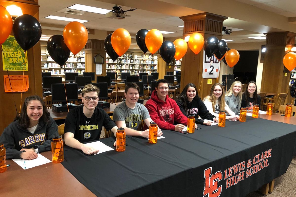 Lewis and Clark seniors signing National Letters of Intent on Wednesday  in the school library. From left: Kate Picanco (track and field, Carroll College); Mitchell Sanders (lacrosse, Dominican University); Joe Schauer (lacrosse, Dominican University); Thomas Ehring (football, Whitworth); Camryn Gardner (soccer, Whitworth); Leah Rodriguez (track and field, Whitworth); Kaylee Bishop (basketball, George Fox); and Dominique Arquette (basketball, Eastern Arizona). (Dave Nichols / The Spokesman-Review)