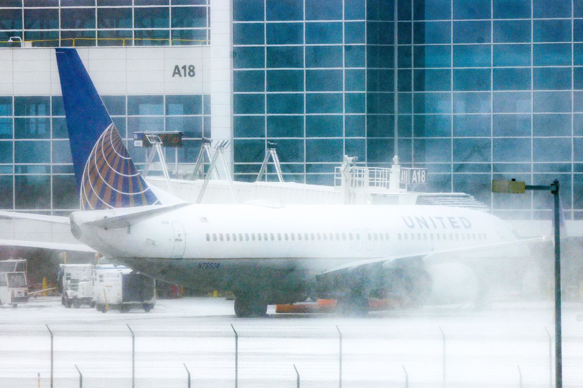 A United Airlines airplane sits at a gate during a winter storm at Denver International Airport on Feb. 22, 2023, in Denver. More than 1000 flights have been canceled across the U.S. as the storm impacts travel around the country.    (Michael Ciaglo/Getty Images North America/TNS)