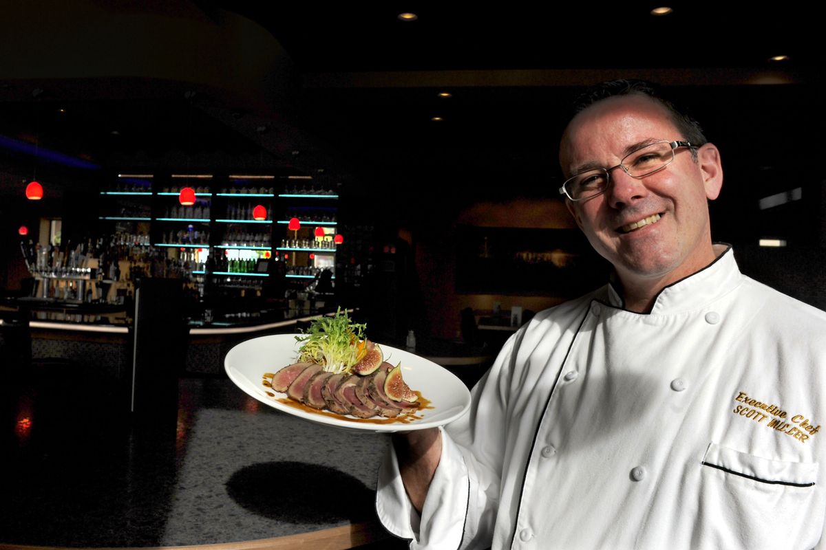 Executive Chef Scott Miller shows off the signature duck entree at Seasons Fresh Grill and Bar. (Kathy Plonka)