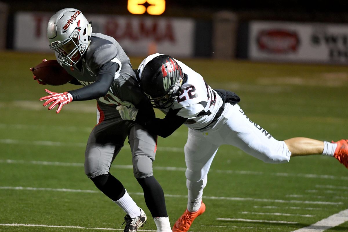 After catching a pass, Ferris wide receiver Braden Brock (20) is tackled by North Central cornerback Jake Healy (22) during the first half of a high school football game at Joe Albi Stadium, Friday, Sept. 23, 2016, in Spokane, Wash. (Colin Mulvany / The Spokesman-Review)