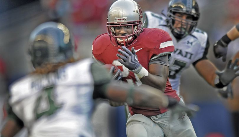 WSU running back James Montgomery tries to find a way through the Hawaii defense. (Christopher Anderson / The Spokesman-Review)