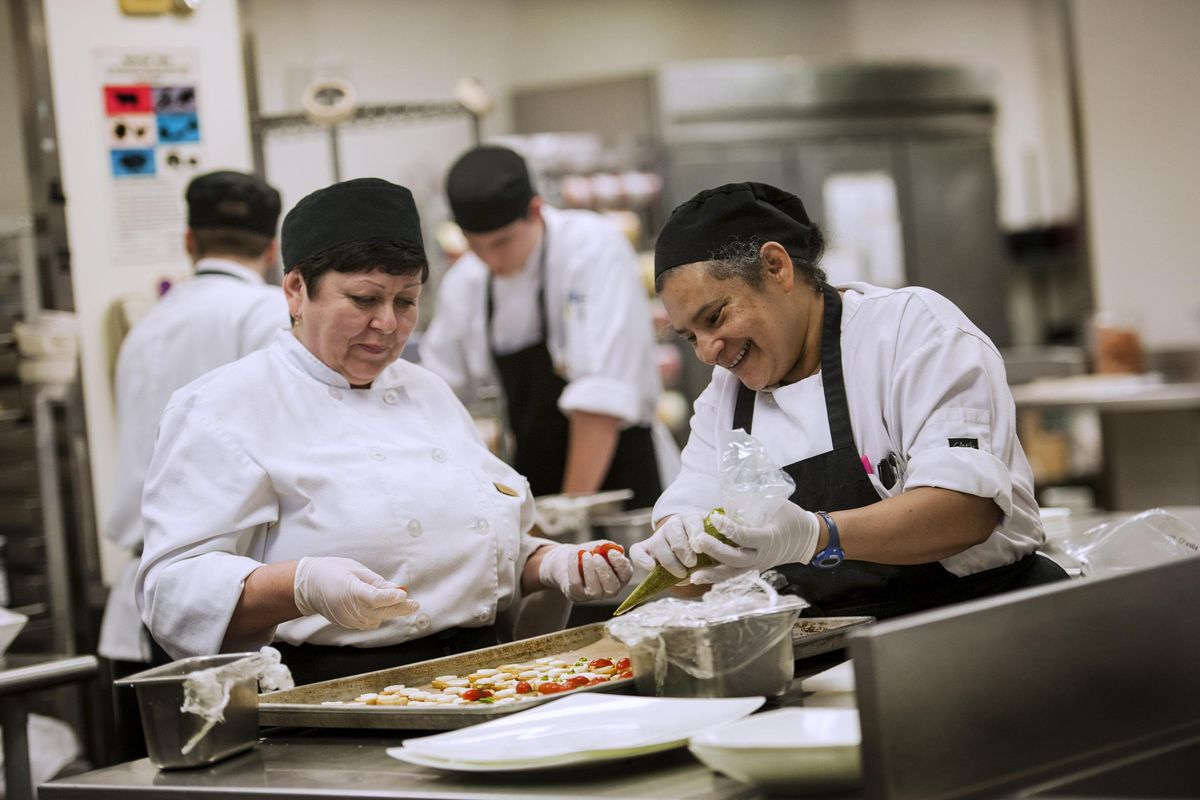 Cold cooks Valentina Gavulovici, left and Candida Pethers work on hors d