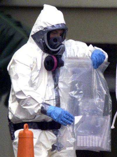 
A worker retrieves swab samples from the offices of American Media Inc. in Boca Raton, Fla., in October 2001. One worker died and another was sickened by anthrax at American Media. 
 (File/Associated Press / The Spokesman-Review)