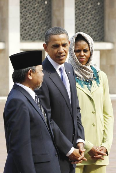 President Barack Obama and first lady Michelle Obama stand with Grand Imam Yaqub as they visit Istiqlal Mosque in Jakarta, Indonesia, Wednesday.  (Associated Press)