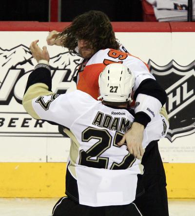 Philadelphia’s Scott Hartnell winds up a punch as he and Pittsburgh’s Craig Adams engage in one of the game’s many fights. (Associated Press)