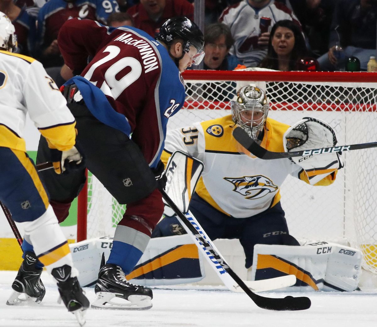 Colorado Avalanche center Nathan MacKinnon, front, fires a shot at Nashville Predators goaltender Pekka Rinne for a goal in the second period of Game 3 of an NHL hockey first-round playoff series Monday, April 16, 2018, in Denver. (David Zalubowski / Associated Press)