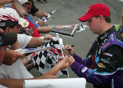 
 Denny Hamlin signs autographs after he posted a lap at 169.827 mph to grab the pole position at Pocono Raceway. 
 (Associated Press / The Spokesman-Review)