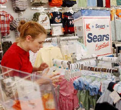 
Kaylin Wilson of Milford, N.H. sets up children's clothes in a K-Mart in Nashua, N.H. 
 (Associated Press / The Spokesman-Review)