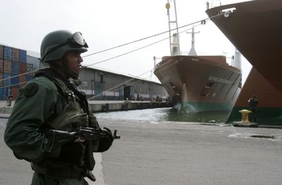 A soldier patrols at the seaport in Puerto Cabello on Saturday, after Venezuela’s President Hugo Chavez seized the air and sea ports.  (Associated Press / The Spokesman-Review)