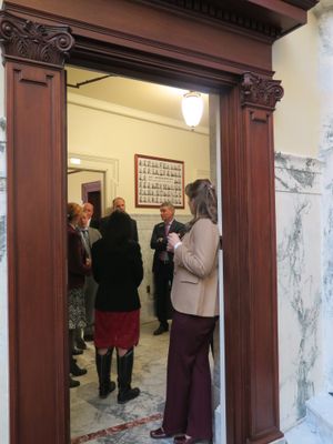 Members of House leadership from both parties huddle with Reps Christy Zito, R-Hammett, and Priscilla Giddings, R-White Bird, in the hallway outside the chamber on Monday over Zito's challenge to leadership on the handling of personal bills. (Betsy Z. Russell)