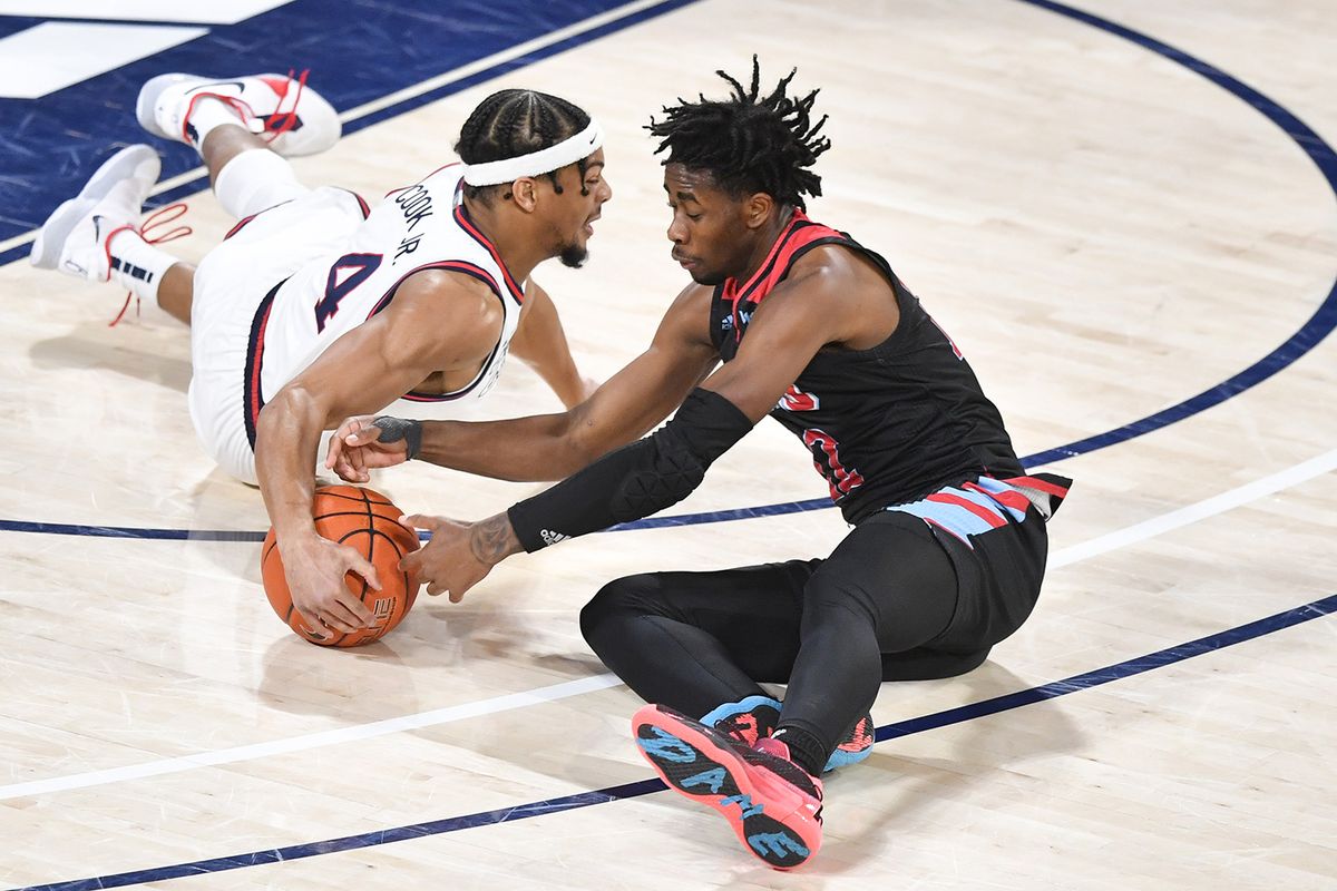 Gonzaga Bulldogs guard Aaron Cook (4) dives for loose ball against LMU during the first half of a college basketball game on Saturday, February 27, 2021, at McCarthey Athletic Center in Spokane, Wash.  (Tyler Tjomsland/The Spokesman-Review)