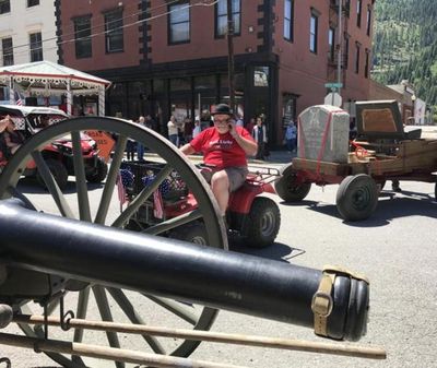 Jamie Baker, main organizer of the Founder’s Day Parade last Saturday, stays on top of the logistics involved in moving the 1-ton tombstone of Col. William Ross Wallace . The tombstone was placed outside the town’s historic railroad depot museum following last Saturday’s Founder’s Day parade. (Doug Clark / The Spokesman-Review)