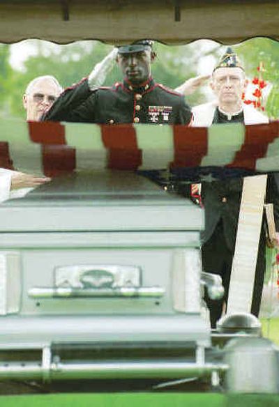 
Gunnery Sgt. Daryle Harris salutes the flag-draped coffin of Congressional Medal of Honor winner Michael 