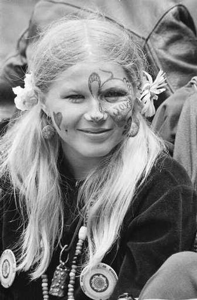 
Judy Smith, sporting face paint and flowers in her hair, smiles as she and others gather at Golden Gate Park in this file photo taken June 21, 1967, in San Francisco, on day one of the 