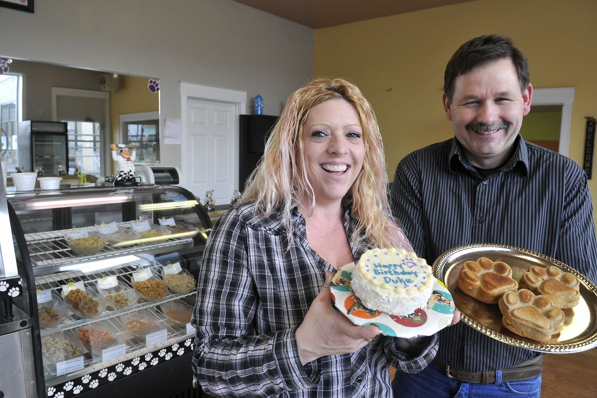 Jeanne and Lonny Kelp hold samples at their store, Dog-Delicious, in Spokane. (Jesse Tinsley)